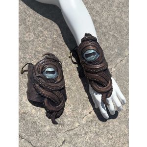 Pair of handmade silicone kraken tentacle gauntlets with glowing blue cyclops eyes and adjustable lace-up arm wraps by Mertailor.